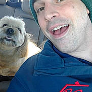 Harry joined the competition — help win amazing prizes! beanie, car_interior, casual_clothing, closeup, companionship, dog, facial_expression, friendship, furry_dog, happy, headwear, human, indoors, light_fur, man, pet, portrait, seated, smiling, vehicle