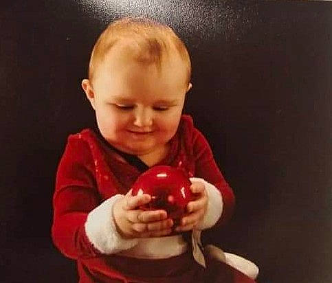 Charity joined the competition — help win amazing prizes! apple, arm, baby, child, facial_expression, food, fruit, head, joy, mouth, person, plant, play, red, toddler