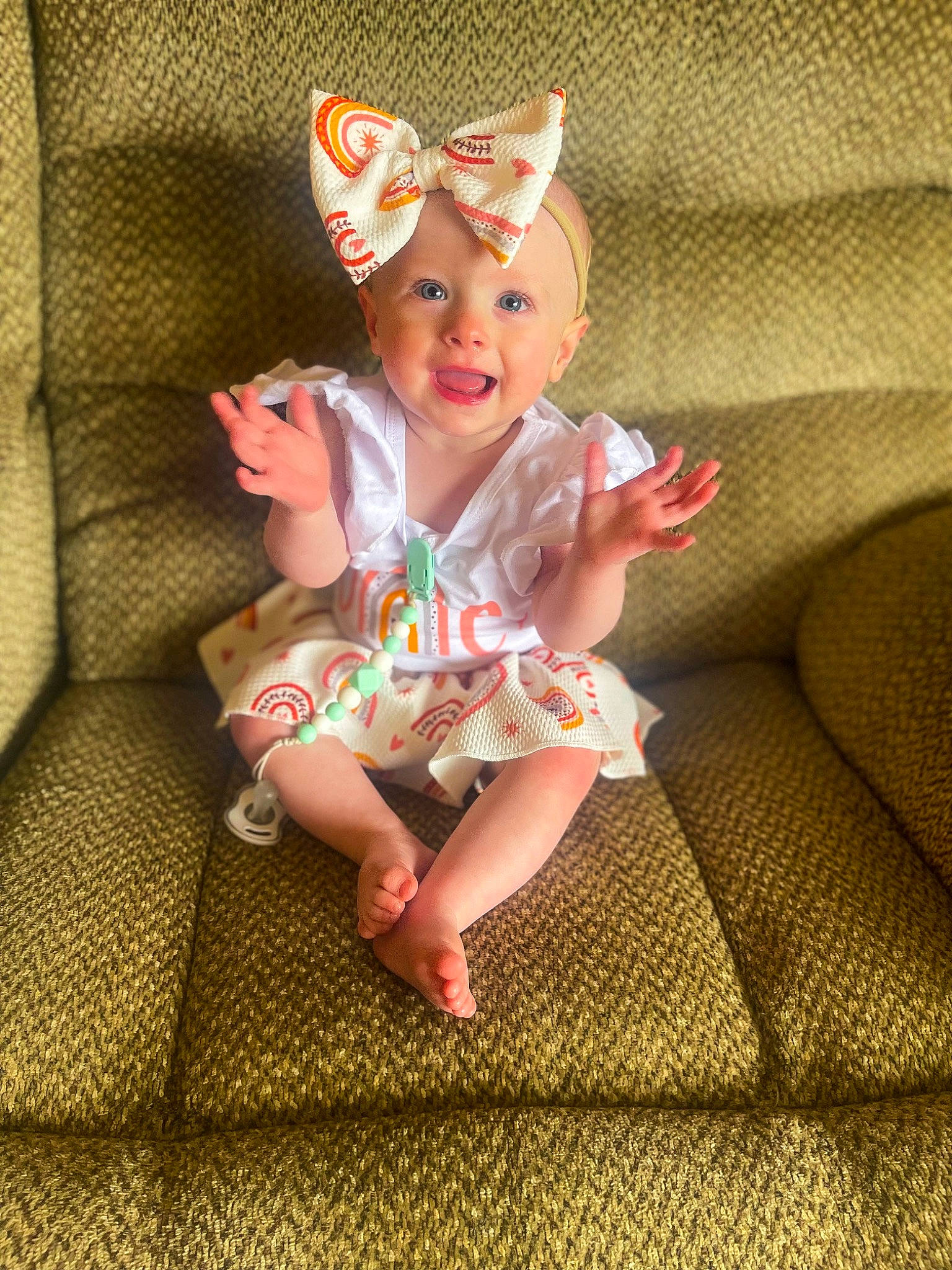 Evelynn is registered to the contest to win money with this photo: baby_toddler_clothing, cap, child, costume_hat, crown, fashion_accessory, foot, fun, grass, happy, head, headpiece, headwear, human_leg, joy, pattern, peach, person, pink, sitting