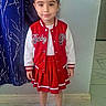 casual_pose, child, curtain, dress, fashion, front_facing, full_body, girl, hair_bows, indoors, portrait, red_jacket, school_uniform, skirt, smiling, sneakers, standing, tiled_floor, wall, young_child