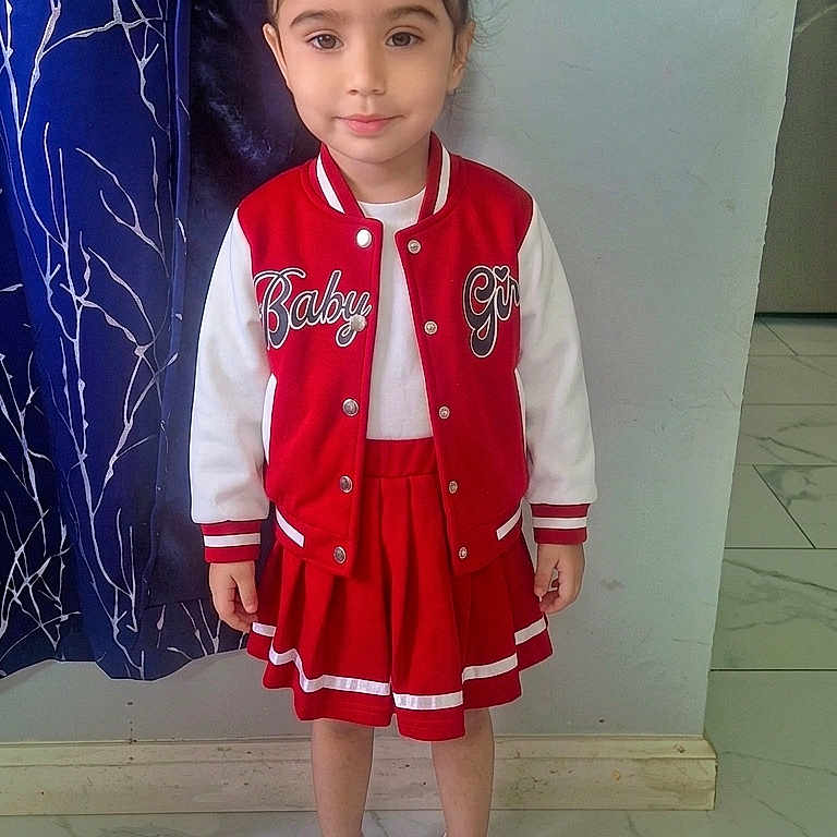 Gursharan joined the competition — help win amazing prizes! casual_pose, child, curtain, dress, fashion, front_facing, full_body, girl, hair_bows, indoors, portrait, red_jacket, school_uniform, skirt, smiling, sneakers, standing, tiled_floor, wall, young_child