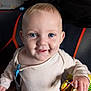 Henry is registered to the contest to win money with this photo: baby, child, blue_eyes, smiling, bread, hand, face, clothing, sitting, indoor, cute, infant, happy, portrait, closeup, skin, toy, blanket, young_child, person