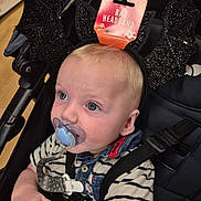 Henry joined the competition — help win amazing prizes! baby, pacifier, bat_headband, stroller, striped_shirt, blue_eyes, denim_collar, black_headband, sparkly, infant, child, cute, baby_clothing, face, hand, seatbelt, indoors, shopping, retail, curious