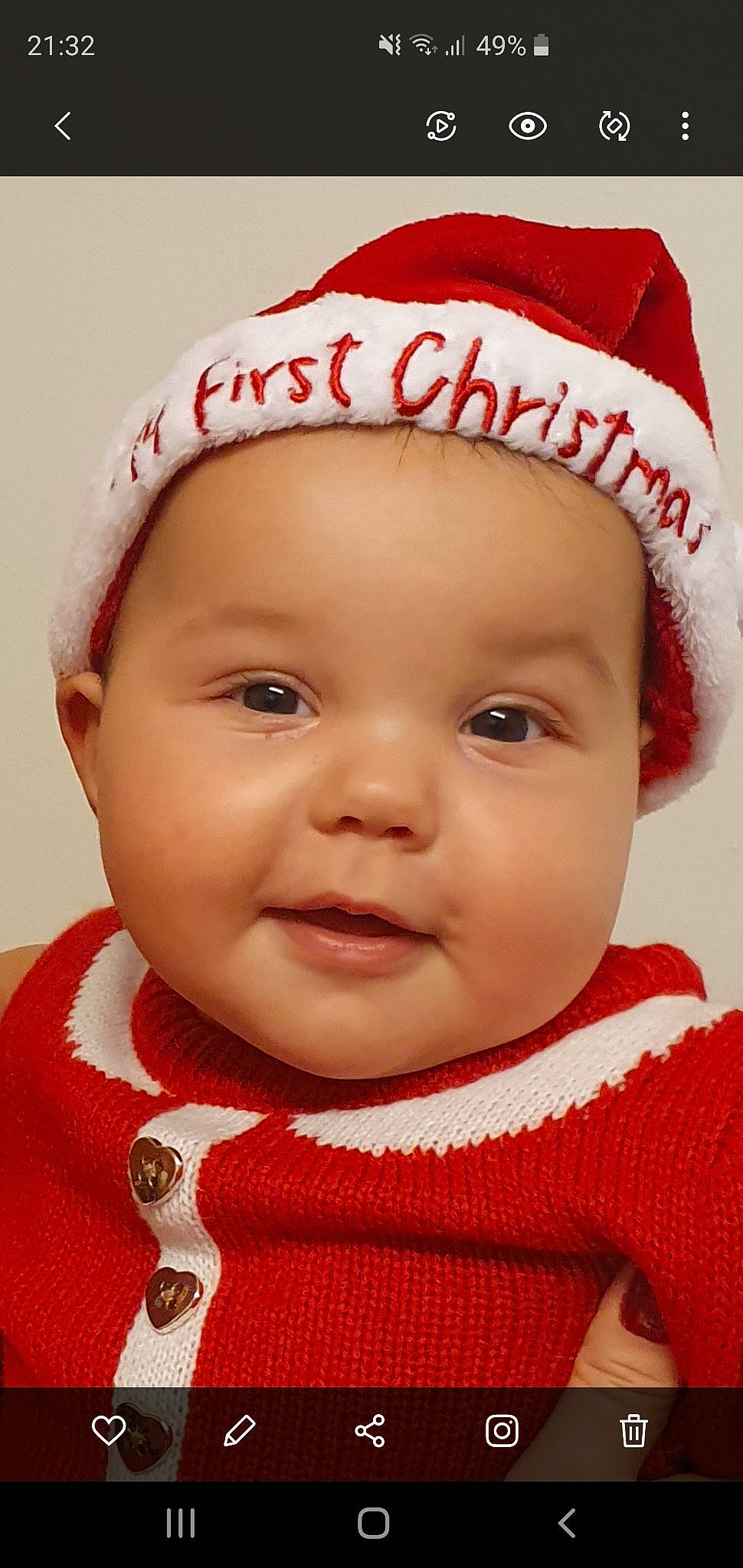 Carina is registered to the contest to win money with this photo: baby, beanie, bonnet, cheek, child, chin, christmas, close_up, face, forehead, head, headgear, knit_cap, lip, mouth, person, red, skin, smile, toddler