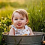 Rory joined the competition — help win amazing prizes! toddler, child, bucket, grass, outdoor, nature, wildflowers, sunlight, blue_eyes, smiling, tongue_out, greenery, portrait, summer, cute, happy, playful, baby, sunset, field