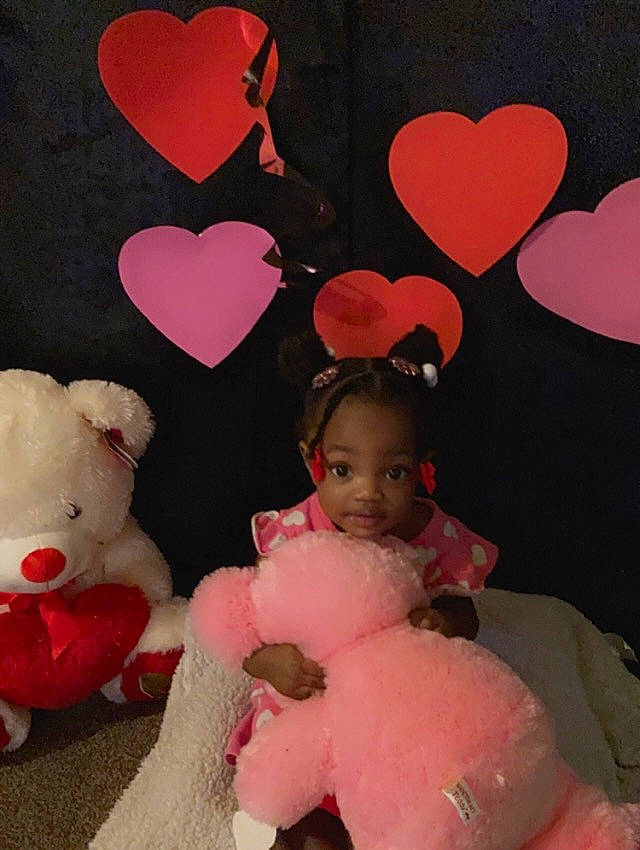 Daliyah is registered to the contest to win money with this photo: baby_toddler_clothing, beauty, carmine, design, event, facial_expression, fur, happy, heart, human_body, magenta, organ, party_supply, peach, person, pink, red, stuffed_toy, teddy_bear, toddler