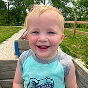 Emmett joined the competition — help win amazing prizes! child, toddler, smiling, portrait, outdoor, park, grass, wooden_wagon, fence, t_shirt, dinosaur_graphic, blond_hair, blue_eyes, candid, happy, close_up, sunlit, playtime, person, wooden_planks
