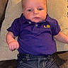 baby, infant, child, polo_shirt, purple_clothing, denim_jeans, couch, pillow, indoor, person, face, head, sitting, furniture, window, home, casual_clothing, expression, soft_lighting, relaxing