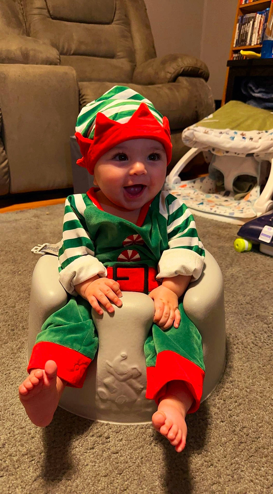 Archer joined the competition — help win amazing prizes! baby, baby_toddler_clothing, cap, carmine, child, christmas, christmas_eve, costume, costume_hat, event, fictional_character, flooring, fun, green, happy, headwear, holiday, lap, person, play