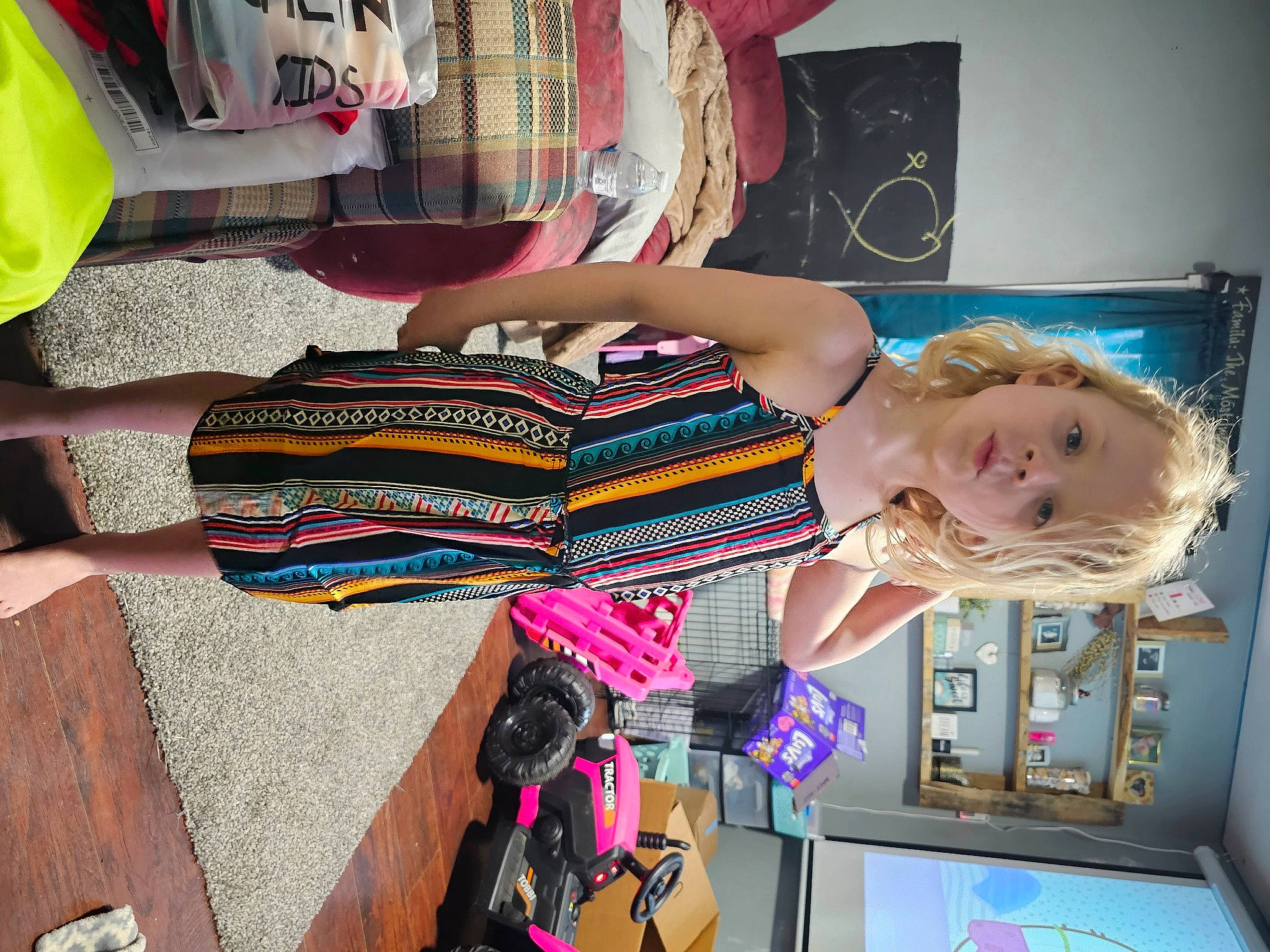 Ella is registered to the contest to win money with this photo: art, baby, child, dress, eyewear, fashion_accessory, fashion_design, fun, happy, human_leg, pattern, person, pink, room, shelf, shelving, snapshot, t_shirt, thigh, toddler