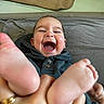 baby, child, laughing, smiling, feet, hand, hoodie, indoor, person, infant, closeup, happy, cute, skin, face, fingers, playful, joy, expression, young