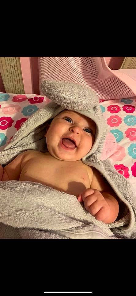 Leena is registered to the contest to win money with this photo: baby, bedtime, cheek, child, facial_expression, happy, headgear, headwear, linens, mouth, nose, person, skin, smile, textile, toddler