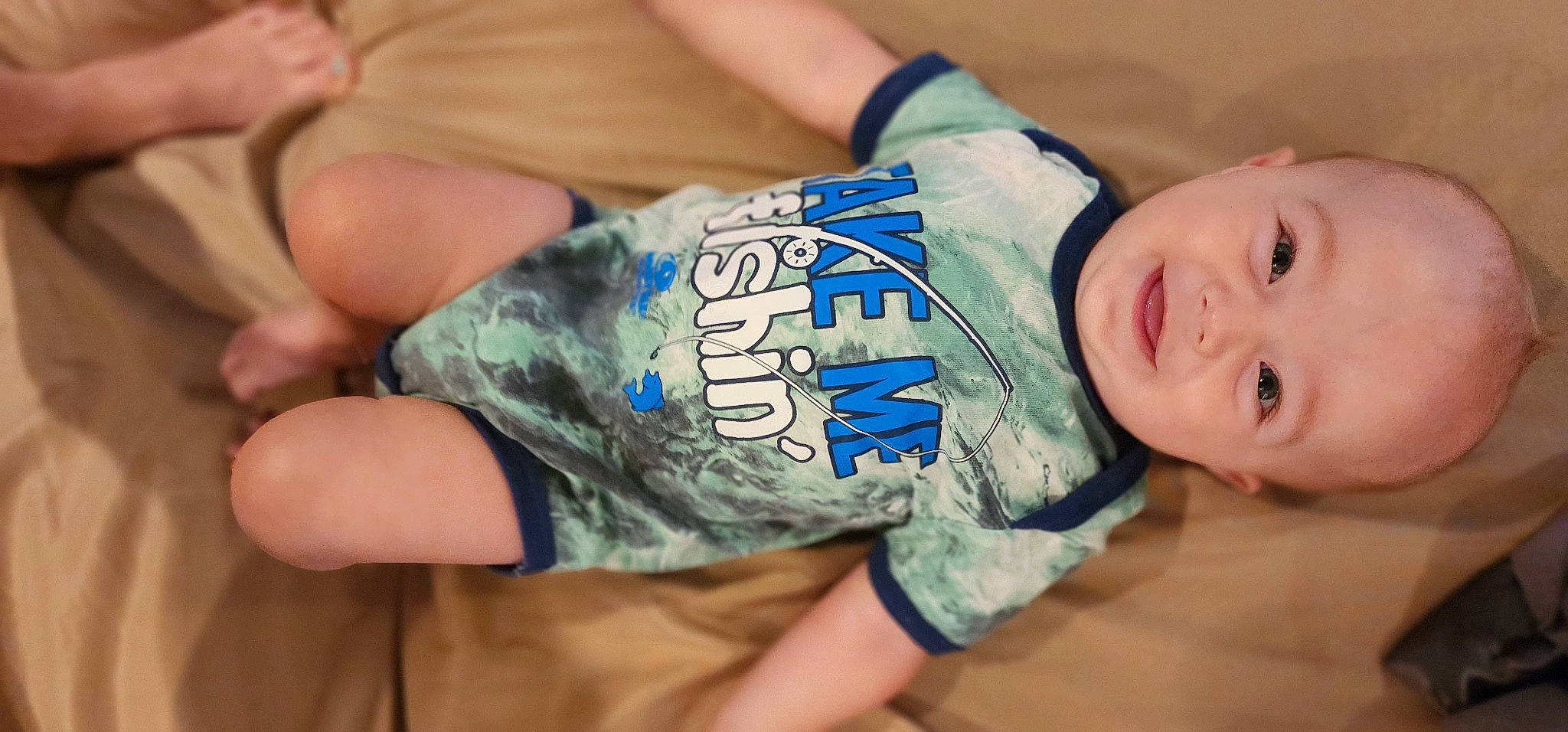 Archer is registered to the contest to win money with this photo: arm, baby_toddler_clothing, child, elbow, finger, gesture, hand, human_body, human_leg, joint, knee, leg, muscle, person, shoulder, skin, sleeve, thigh, thumb, toddler