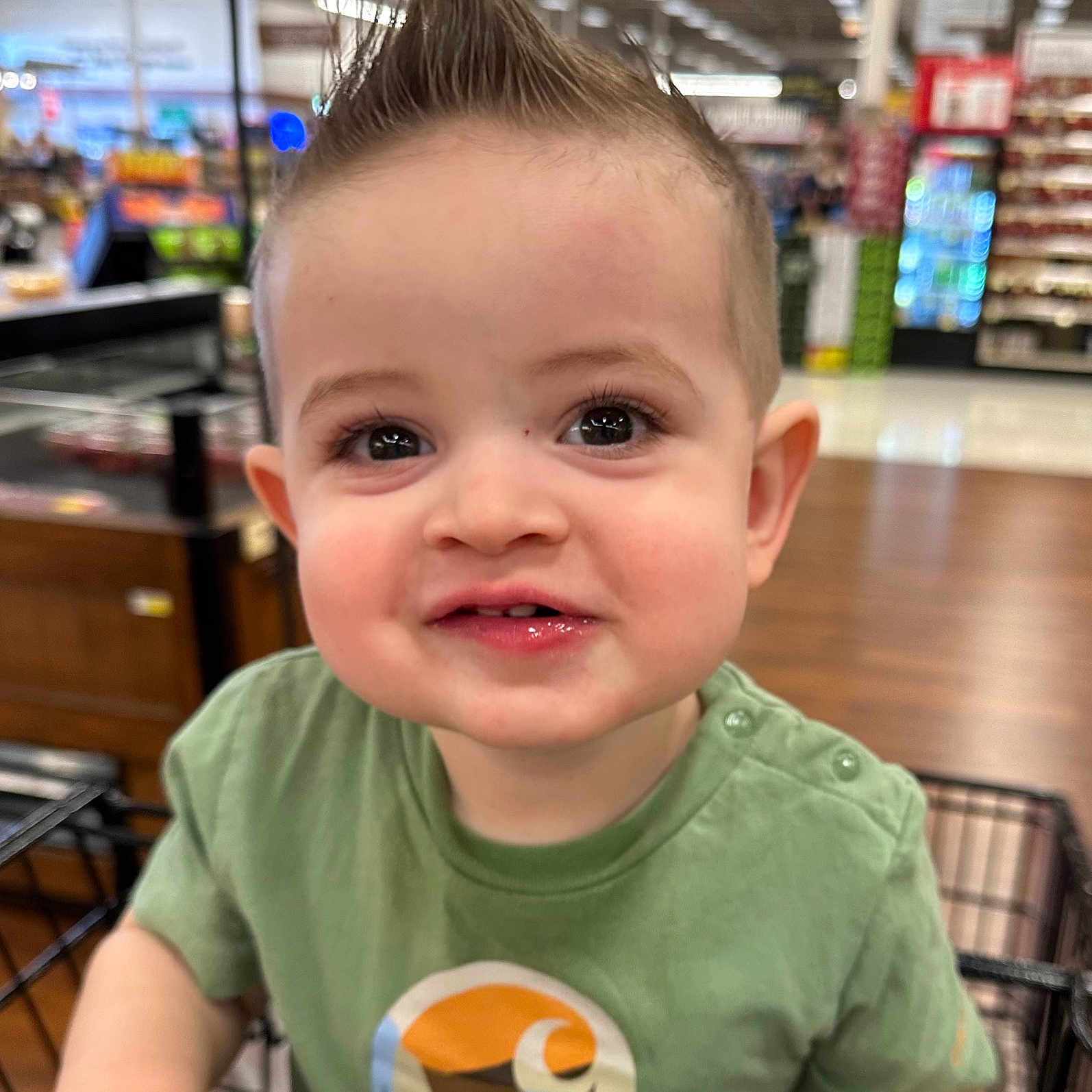 Trace is registered to the contest to win money with this photo: baby, blackhair, blonde, city, clothing, face, grocerystore, hair, happy, head, indoors, mohawkhairstyle, person, photography, portrait, shelf, shop, shopping, smile, t_shirt