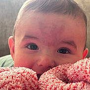 Kaiden is registered to the contest to win money with this photo: baby, face, blanket, pink, red, closeup, infant, cute, child, soft, texture, eyes, portrait, young, cozy, warm, indoor, expression, head, skin
