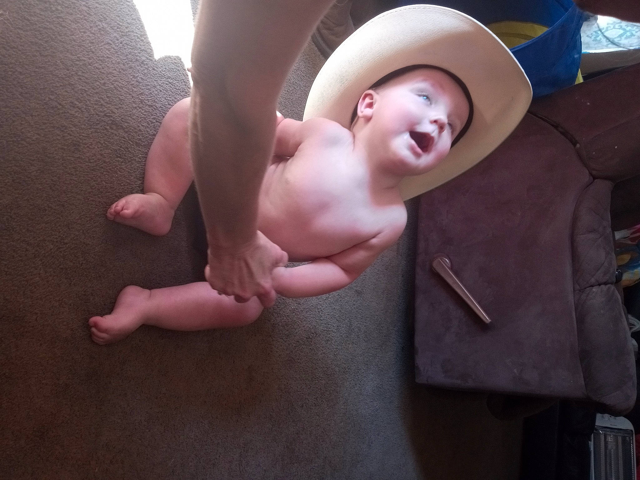 Caleb is registered to the contest to win money with this photo: baby, chest, child, comfort, cowboy_hat, eye, face, fedora, finger, flash_photography, gesture, happy, hat, human_body, person, smile, stomach, sun_hat, toddler, trunk