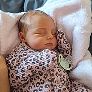 Athena is registered to the contest to win money with this photo: baby, blanket, child, comfort, cozy, cute, fabric, indoors, infant, leopard_print, newborn, onesie, pacifier, peaceful, pink, portrait, resting, sleeping, soft, toddler