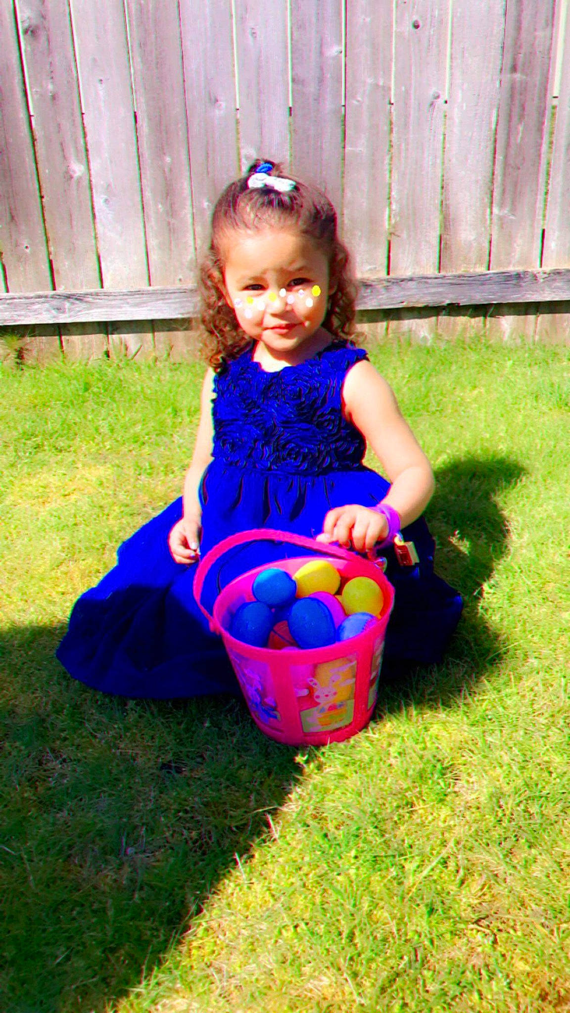 Lillianna is registered to the contest to win money with this photo: baby_toddler_clothing, ball, blue, dress, easter, easter_egg, electric_blue, fence, grass, happy, holiday, joy, lawn, leisure, magenta, pattern, people_in_nature, person, pink, recreation