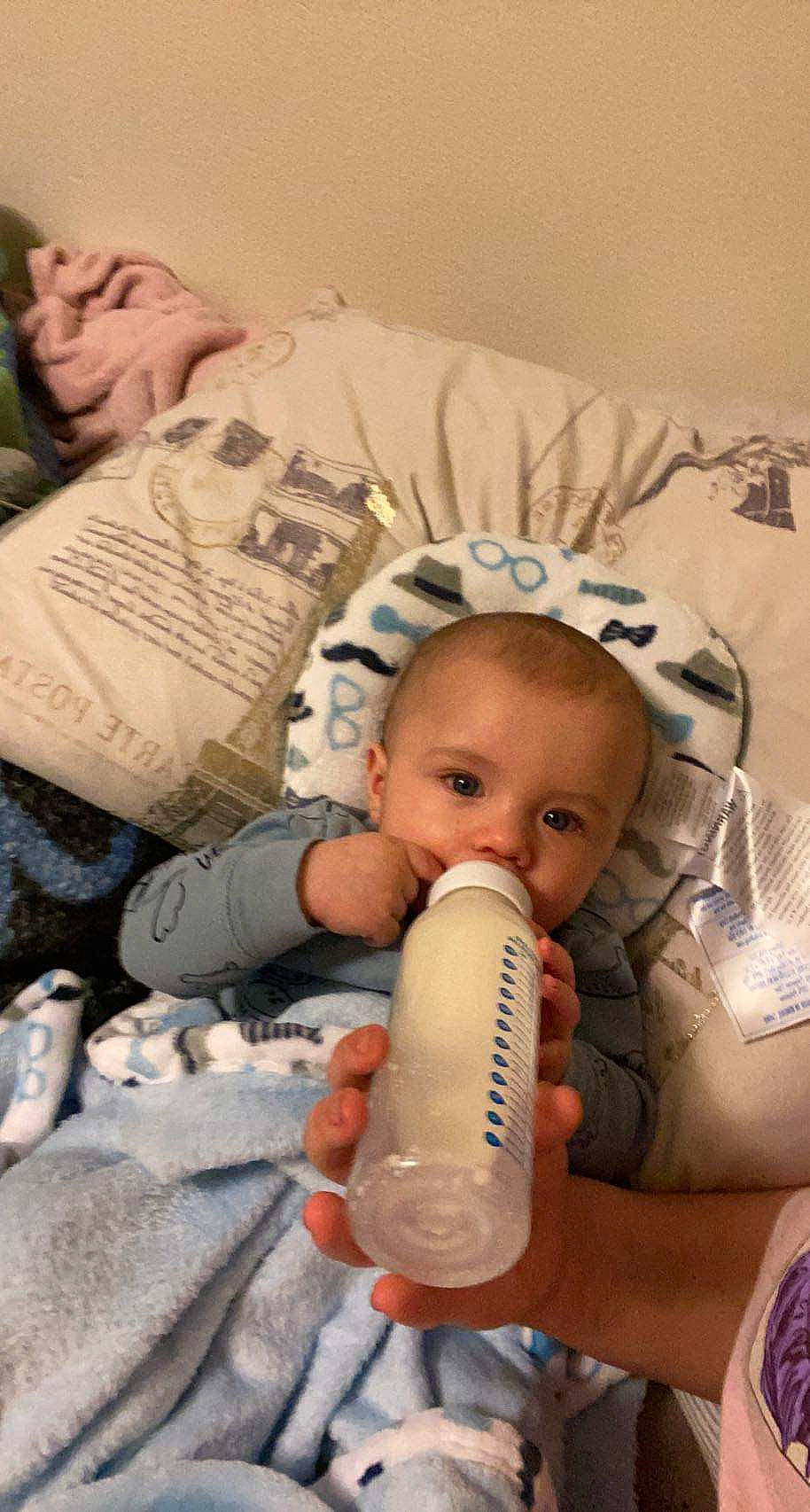 Eivind is registered to the contest to win money with this photo: baby, baby_bottle, baby_products, cheek, child, comfort, drinkware, eyelash, finger, health_care, human, mouth, nail, nose, people, person, plastic_bottle, service, skin, thumb