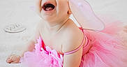 Isabella joined the competition — help win amazing prizes! baby, child, pink_tutu, fairy_wings, headband, smiling, happy, cute, infant, portrait, costume, soft_blanket, indoors, crawling, playful, tulle, dress, celebration, joy, person