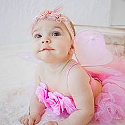 Isabella joined the competition — help win amazing prizes! baby, infant, pink, fairy_wings, headband, flower, tutu, tulle, cute, child, portrait, costume, soft_texture, indoor, white_background, adorable, smiling, curious, hands, lying_down