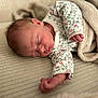 newborn, baby, sleeping, blanket, floral_onesie, cozy, soft_texture, peaceful, infant, resting, cute, portrait, indoor, closeup, human, skin, head, hand, clothing, relaxation