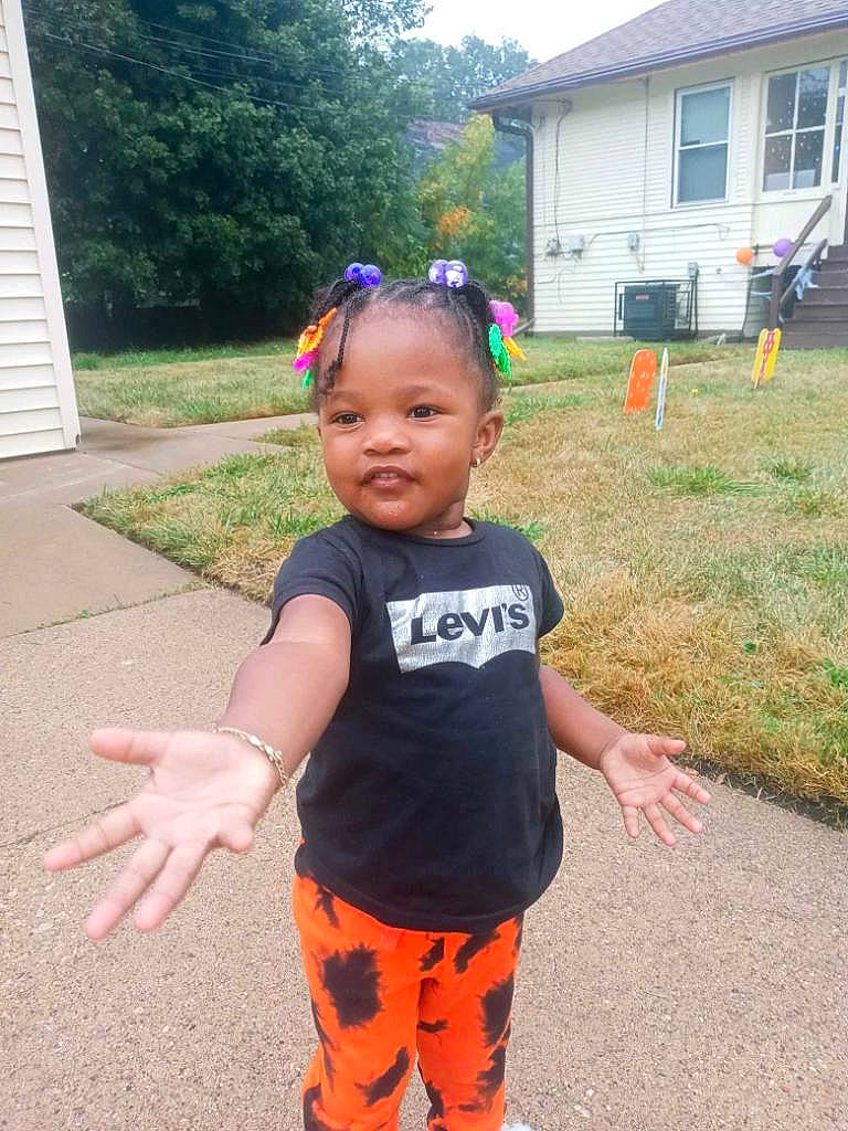 Angenise is registered to the contest to win money with this photo: asphalt, baby, baby_toddler_clothing, child, eye, fun, grass, hair, happy, house, leisure, person, personal_protective_equipment, plant, recreation, sleeve, t_shirt, thigh, toddler, tree