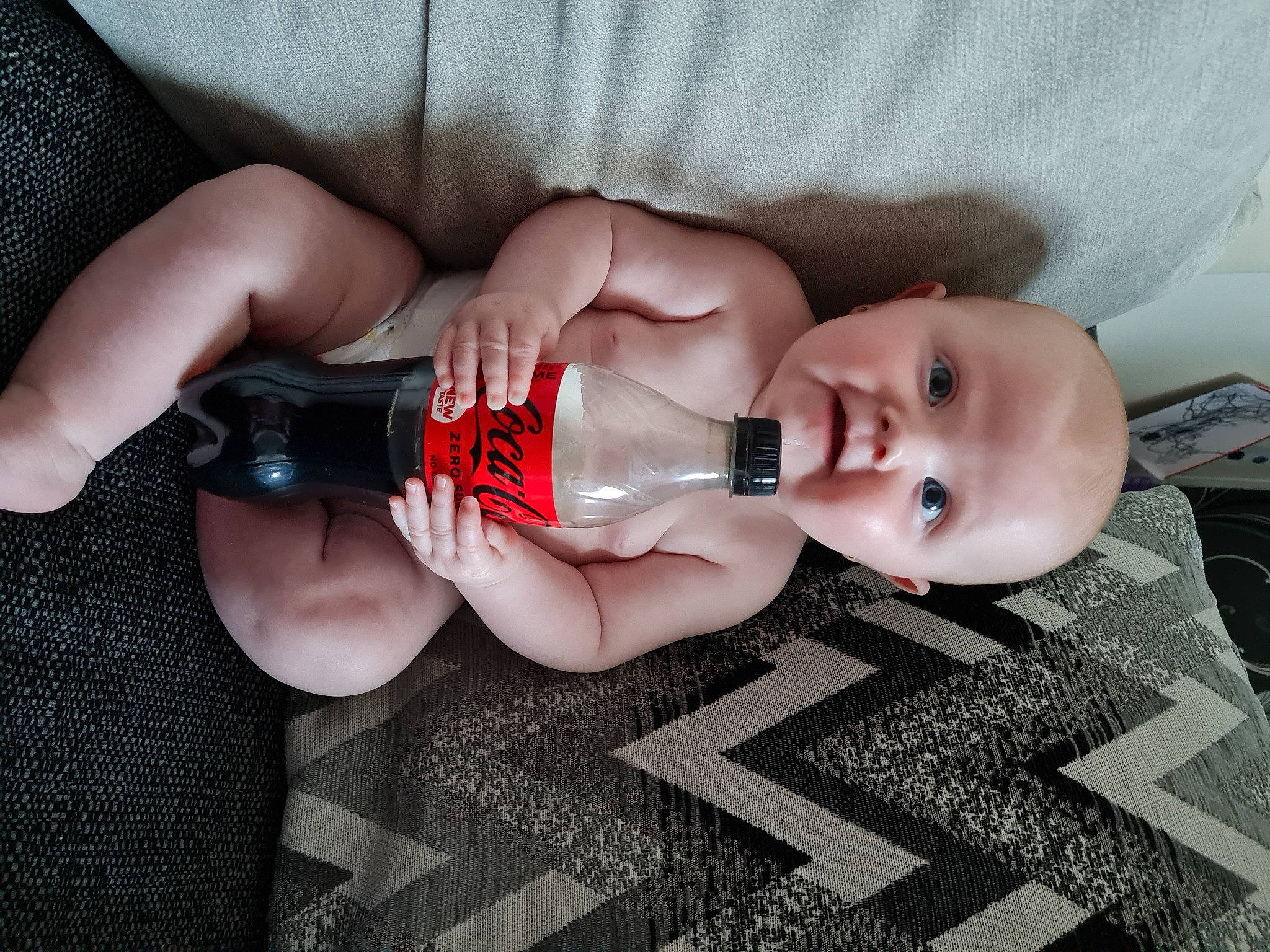 Gracie-may joined the competition — help win amazing prizes! baby, baby_toddler_clothing, bottle, dress, drinking, drinkware, eyelash, finger, flooring, hand, human_leg, leg, nail, person, plastic_bottle, product, skin, thumb, toddler, water