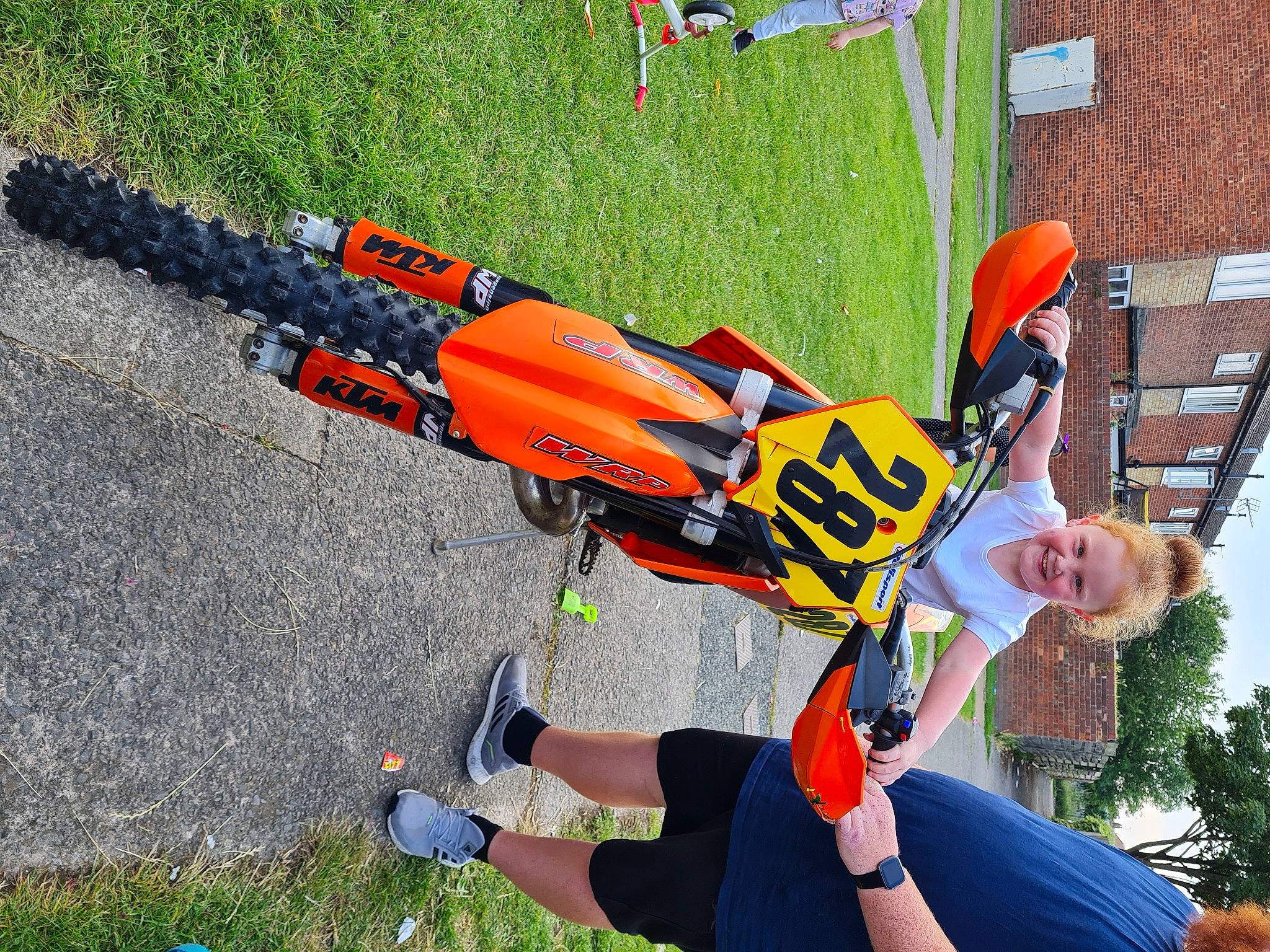 Hayley-rose is registered to the contest to win money with this photo: adventure, asphalt, bicycle_frame, bicycle_handlebar, bicycle_helmet, carmine, fun, grass, joy, leisure, machine, monoplane, person, personal_protective_equipment, plant, radio_controlled_toy, recreation, smile, sports, toy