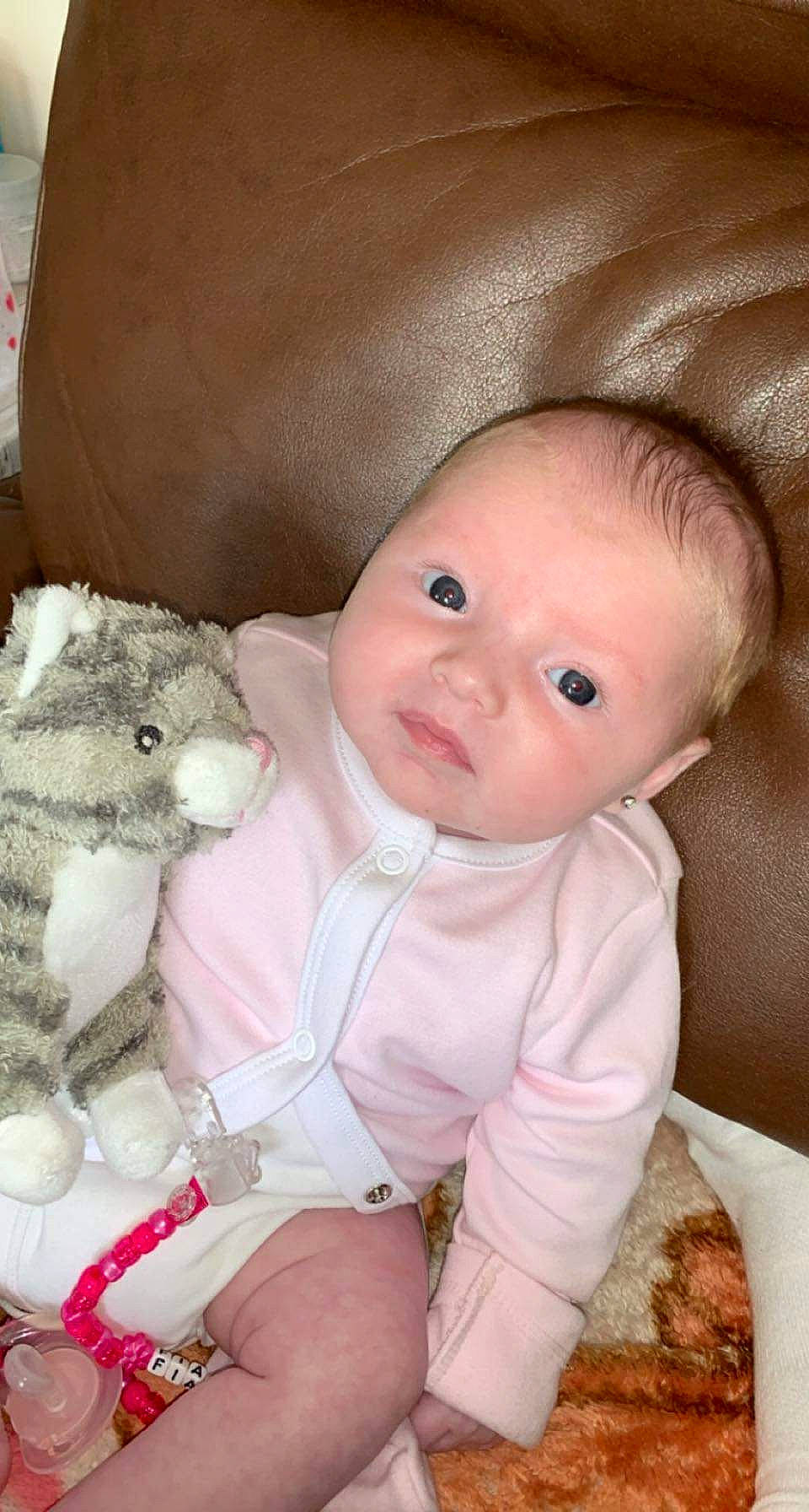 Fiadh is registered to the contest to win money with this photo: baby, baby_toddler_clothing, cheek, child, comfort, eye, face, headgear, iris, lip, mammal, nose, organ, person, pink, product, skin, sleeve, textile, vertebrate