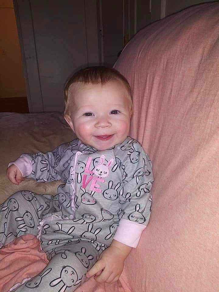 Elia is registered to the contest to win money with this photo: baby, cheek, child, eye, face, head, iris, person, pink, sitting, skin, smile, toddler