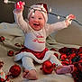 Athena is registered to the contest to win money with this photo: baby, blanket, celebration, child, christmas, clothing, cute, feet, festive, happy, holiday, indoors, lights, ornaments, red, santa_hat, smile, toddler, toy, white