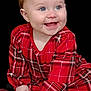 baby, black_background, black_shoes, blue_eyes, child, clothing, cute, face, hands, happy, infant, long_sleeves, person, plaid, portrait, red_dress, sitting, smiling, studio, young