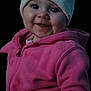 baby, black_background, child, closeup, clothing, cute, face, happy, hat, headwear, hoodie, indoor, infant, knit_hat, person, pink_jacket, portrait, smile, warm_clothing, young_child