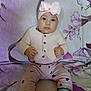 baby, blanket, bow, child, cozy, cute, expression, face, feet, floral_pattern, hands, headband, heart_pattern, indoor, infant, person, pink_clothing, portrait, sitting, socks