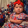 baby, child, infant, red_headband, floral_dress, blue, red, white, stars, decorations, patriotic, celebration, portrait, cute, sitting, face, hands, indoor, festive, holiday