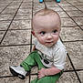 Ryder joined the competition — help win amazing prizes! baby, child, toddler, sitting, floor, tile_floor, green_pants, white_shirt, sneakers, curly_hair, mohawk, indoor, store, walker, toy, person, cute, young_child, looking_away, casual_clothing
