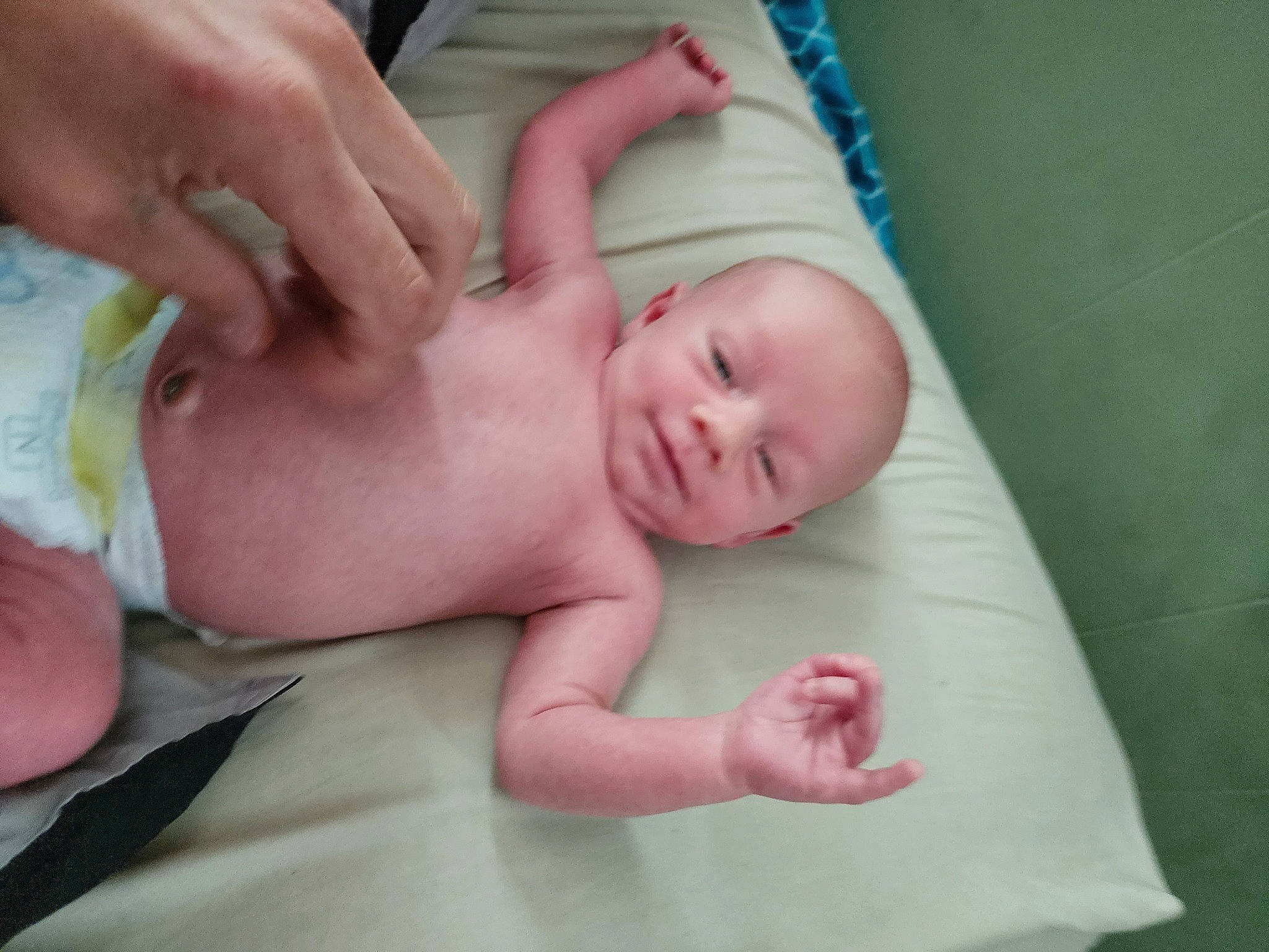 Jeremy is registered to the contest to win money with this photo: abdomen, baby, baby_products, baby_toddler_clothing, cheek, child, comfort, finger, gesture, grass, hand, head, human_body, linens, nail, person, pink, room, skin, thumb