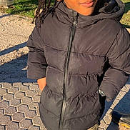 Jahïden participe au concours pour gagner de l'argent avec cette photo : child, braided_hair, black_jacket, outdoor, park, sunlight, grass, pavement, person, thoughtful, casual_clothing, young, standing, cold_weather, nature, daylight, expression, face, portrait, winter
