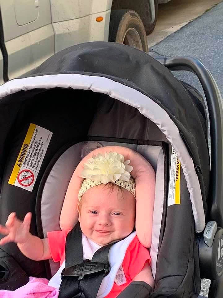 Ava joined the competition — help win amazing prizes! automotive_design, automotive_tire, baby, baby_carriage, black, event, face, fender, fun, happy, headwear, joy, motor_vehicle, person, plant, smile, synthetic_rubber, tie, tire, toddler