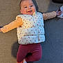 Ella participe au concours pour gagner de l'argent avec cette photo : baby, smiling, couch, vest, cherry_pattern, pink_leggings, white_socks, arms_spread, happy, indoor, child, infant, face, clothing, person, portrait, lying_down, cute, home, cozy