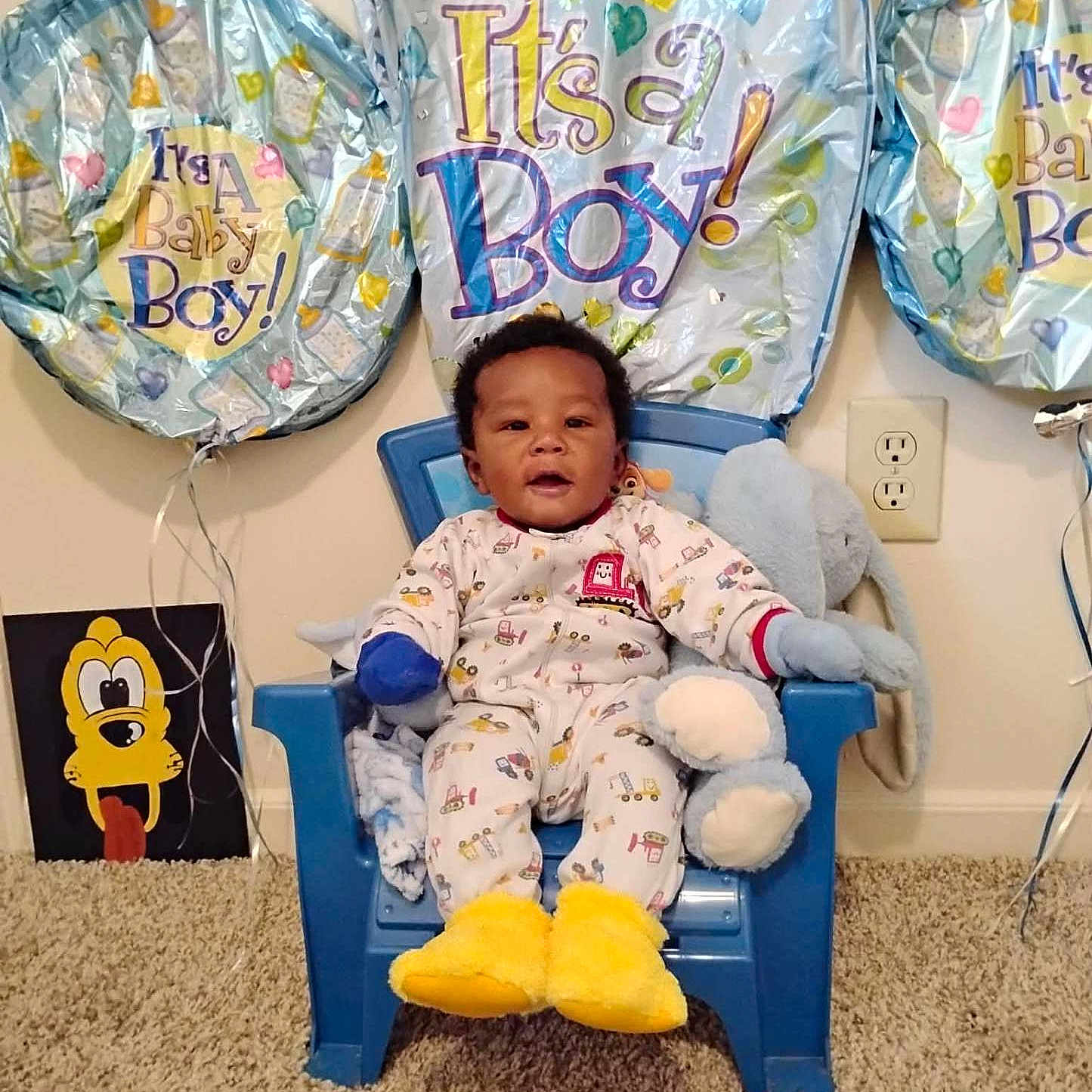 Mei'Leontah joined the competition — help win amazing prizes! baby, child, boy, balloons, celebration, chair, pajamas, stuffed_animal, carpet, wall_outlet, painting, yellow_slippers, blue_chair, indoor, smiling, cute, home, toy, happy, person