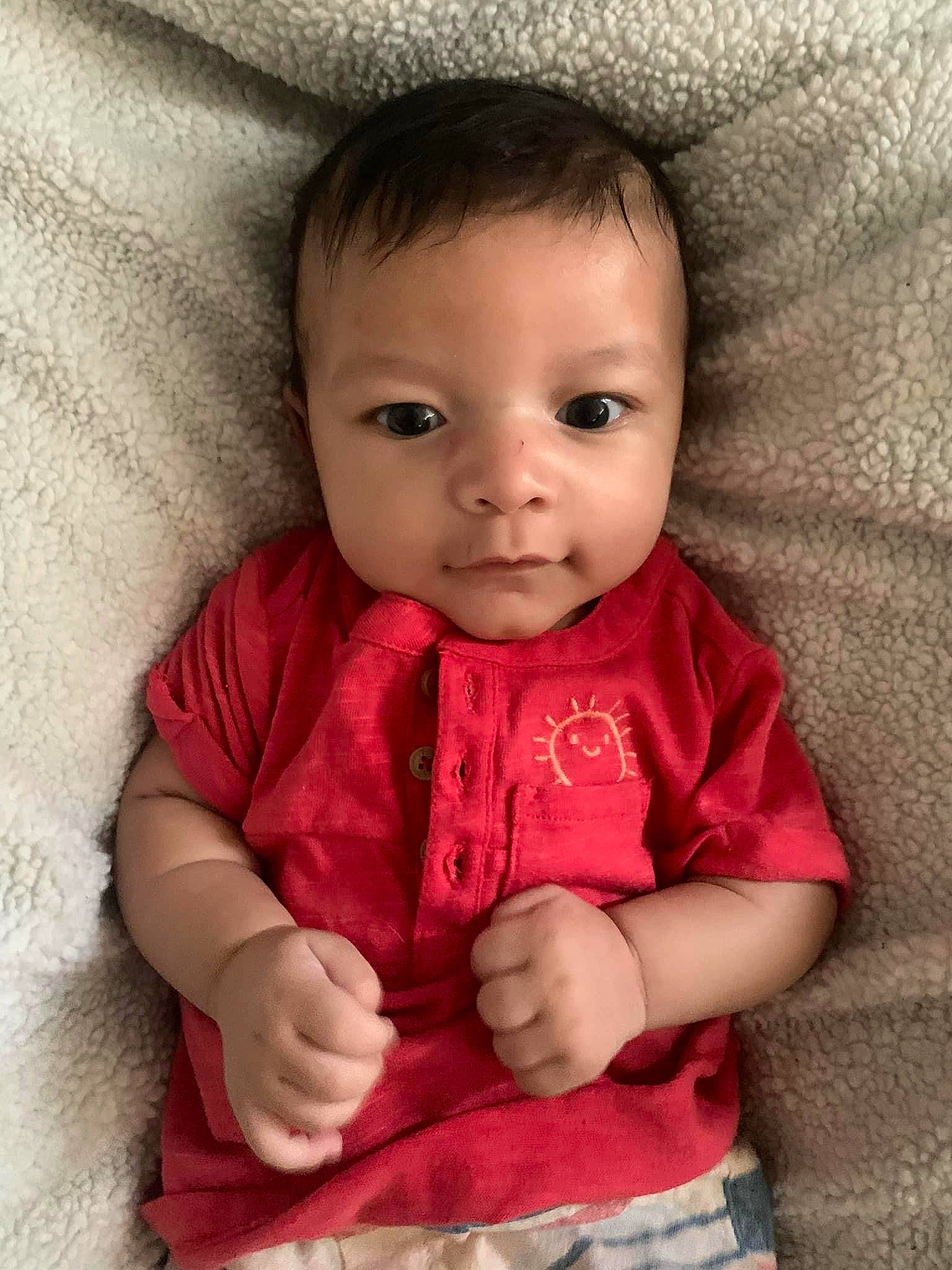 Junior is registered to the contest to win money with this photo: baby, baby_toddler_clothing, cheek, child, collar, comfort, eyelash, gesture, hair, happy, iris, linens, lip, nose, person, sitting, skin, sleeve, smile, thumb