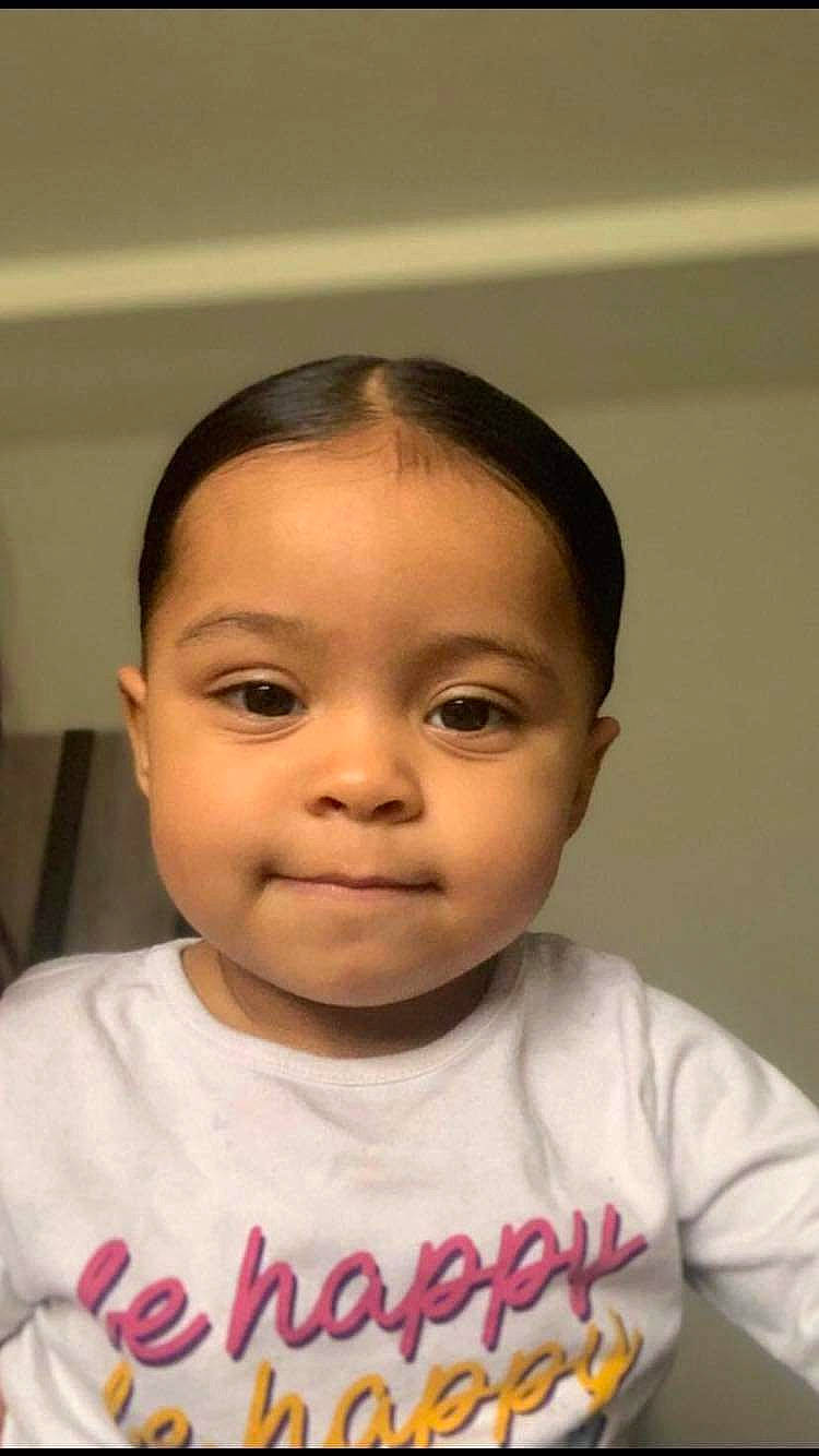 Kamilah is registered to the contest to win money with this photo: baby, baby_toddler_clothing, black_hair, cheek, eyebrow, eyelash, forehead, gesture, happy, iris, jaw, lip, mouth, neck, nose, person, skin, sleeve, smile, t_shirt