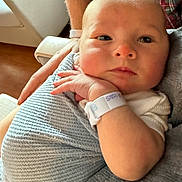 Francis joined the competition — help win amazing prizes! baby, infant, blanket, hospital_wristband, arm, hand, face, person, newborn, wrapped, curious, indoor, closeup, skin, clothing, plaid, comfort, caring, resting, soft