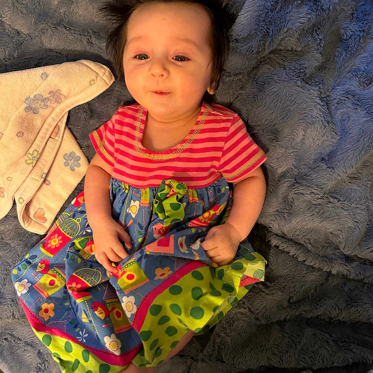 Raven is registered to the contest to win money with this photo: baby, blanket, clothing, couch, cushion, dress, face, furniture, hair, happy, head, homedecor, pants, person, photography, portrait, quilt, sitting, smile, t_shirt