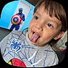 Angelrey is registered to the contest to win money with this photo: child, boy, tongue_out, playful, spiderman_shirt, superhero, captain_america, costume, indoor, portrait, cute, face, happy, casual_clothing, brown_hair, young, person, fun, smile, background