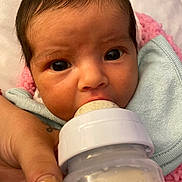 Emily joined the competition — help win amazing prizes! baby, bottle, milk, hand, nail_art, face, eyes, blanket, feeding, infant, closeup, person, skin, pink, blue, newborn, care, comfort, nurturing, soft