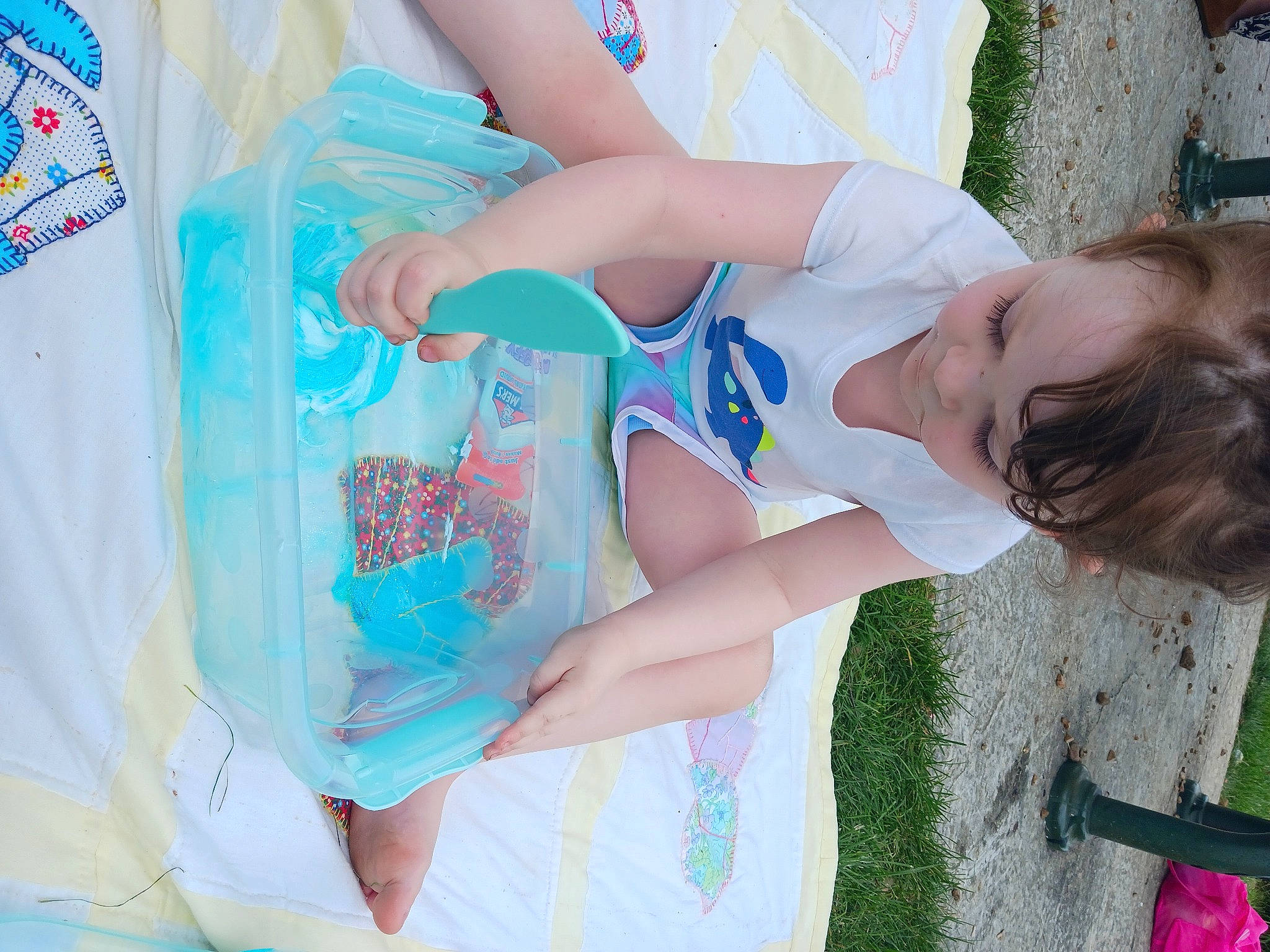 Erin is registered to the contest to win money with this photo: child, elbow, electric_blue, event, fun, grass, happy, human_leg, joint, leisure, pattern, person, plant, recreation, sleeve, t_shirt, textile, thigh, vacation, wrist