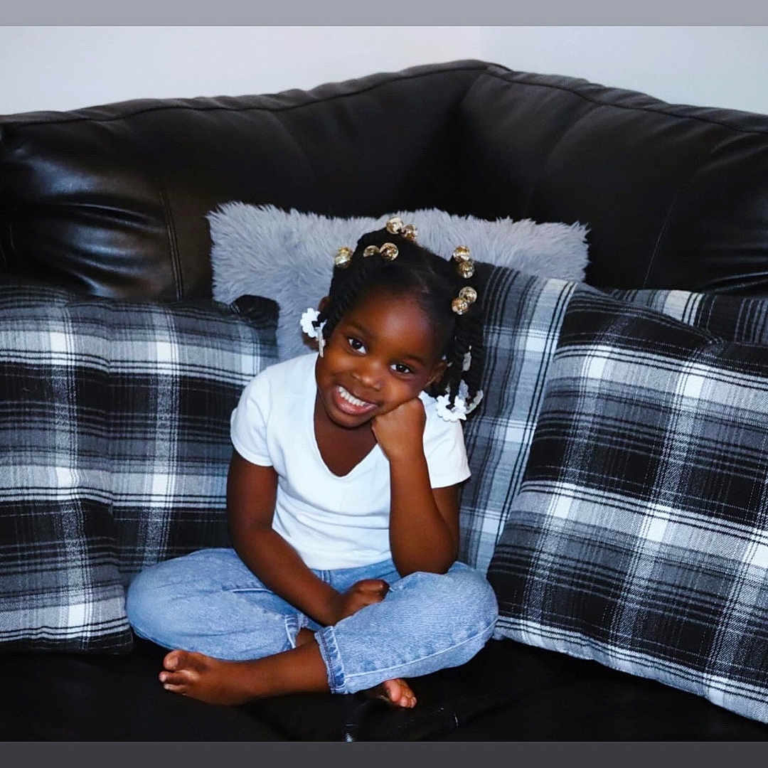 Nehlani joined the competition — help win amazing prizes! architecture, building, child, clothing, couch, cushion, face, female, furniture, girl, happy, head, homedecor, indoors, jeans, pants, person, photography, portrait, sitting